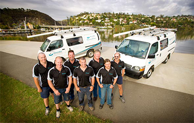 part of our plumbers in Montgomery Village standing by their trucks ready to help